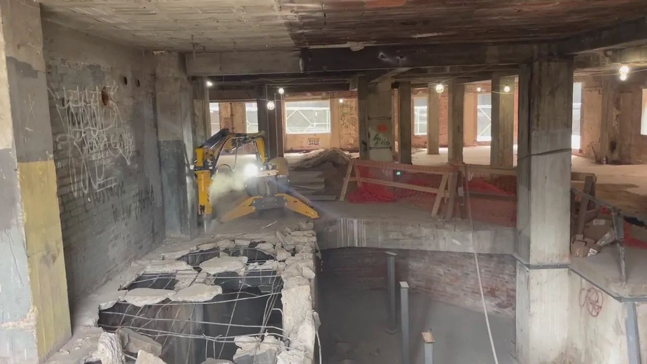 ELEV8 operator running a remote-controlled Brokk demolition robot in the basement of the historic Ambassador Hotel, downtown Jacksonville
